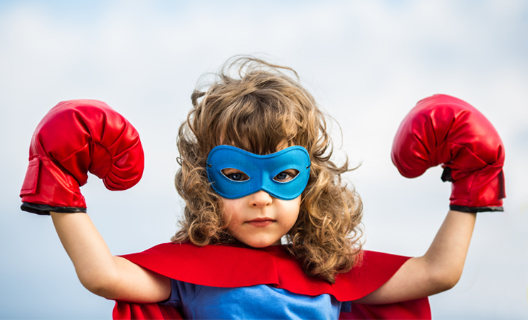 Photo of little girl dressed up as a super hero.